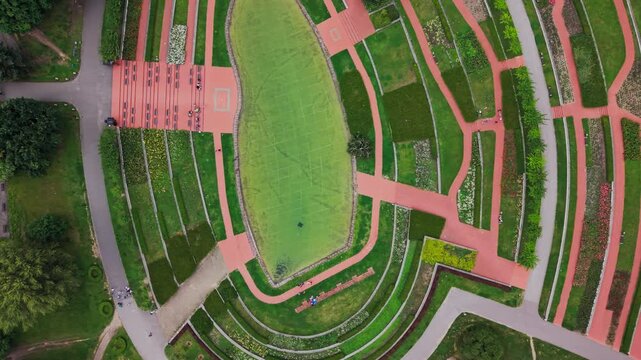 Green Urban Park Forest Top View Drone Flight City Life Leisure Wellness Lifestyle Commercial. A scenic low-angle and top-down panning drone perspective moving smoothly across dense green treetops