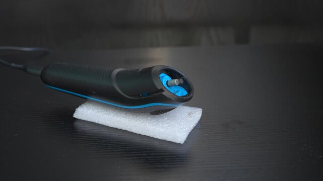 High-quality sound recording in uncompressed WAV format of a men's beard trimmer with the shaving head removed, showing the exposed spinning motor and buzzing mechanism for editing and audio library