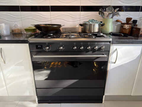 Kitchen oven with cooking pans and window light