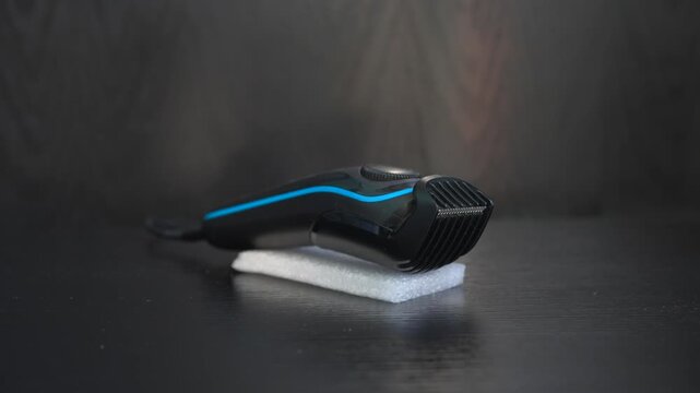 High-quality sound recording in uncompressed WAV format of a men's beard trimmer running steadily, captured as clear electric grooming appliance audio with a sharp motor buzz for audio library use.