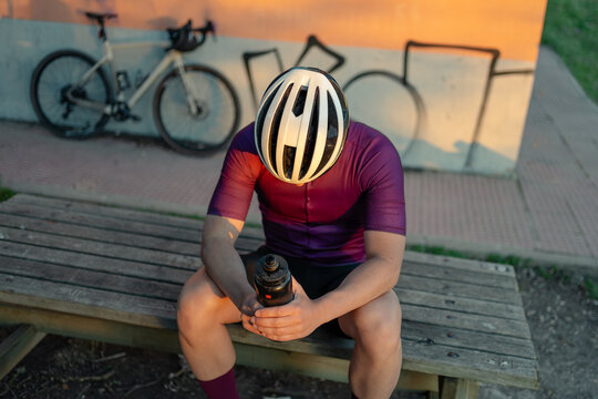 Cyclist resting after exploring gravel terrain
