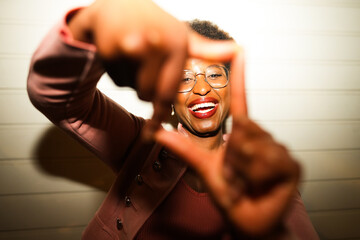 Happy african woman having fun at night time taking photos - Party, nightlife and people lifestyle concept - UGC flash content - Main focus on face