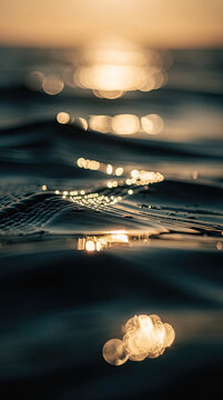 Golden Bokeh Light Reflections on Dark Water Surface, Abstract Background Design
