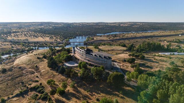 Aerial drone view of ancient hilltop ruins above river Adaja in dry Castilian landscape Spain
