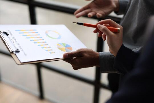 Business colleagues analyzing financial data during an office meeting.