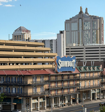 Large Showboat casino hotel in Atlantic City with a prominent vintage sign, multi-level parking garage and ornate balcony capturing urban entertainment architecture and travel vibe.