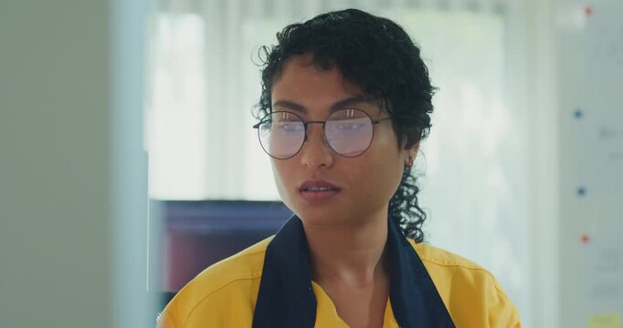Close-up young Black female robotics engineer coding AI software for robotic arm in laboratory. Embedded system, firmware testing, machine learning, industrial automation, future technology concept.