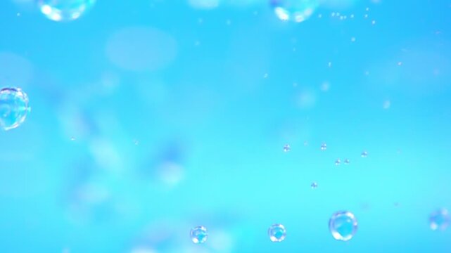 ascent of bubbles in vibrant blue water, an ideal backdrop for projects focused on serenity and nature, slow motion