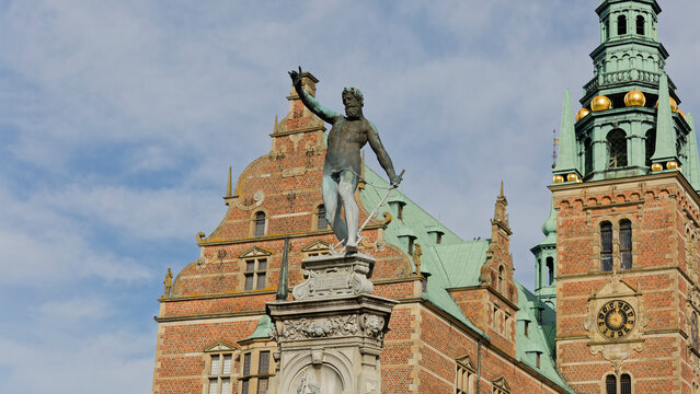 Neptune fountain with kronborg castle in elsinore, denmark