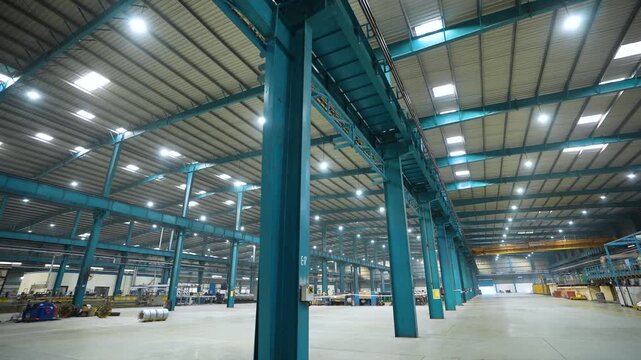 large factory inside, lifter moving inside the manufacturing plant. technical production factory. well lit production facility