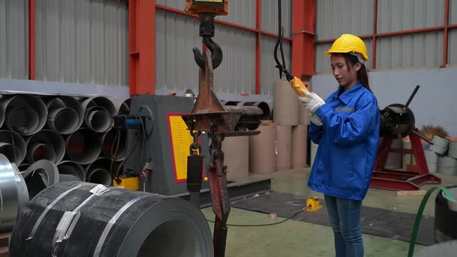 Female operator controlling overhead crane safely