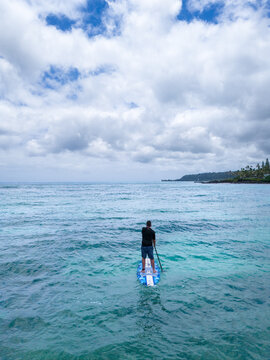 Lone Figure Standing by Tropical Ocean