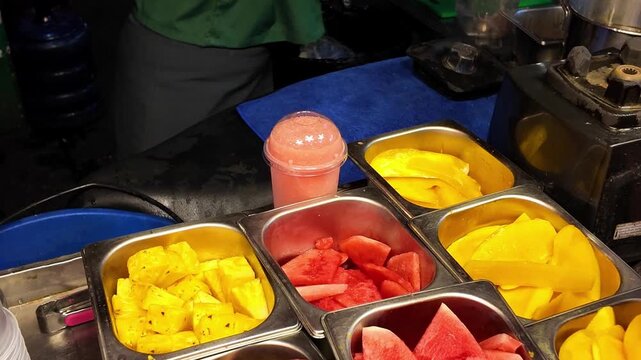 Fresh Tropical Fruit Smoothie Being Poured at Street Market
