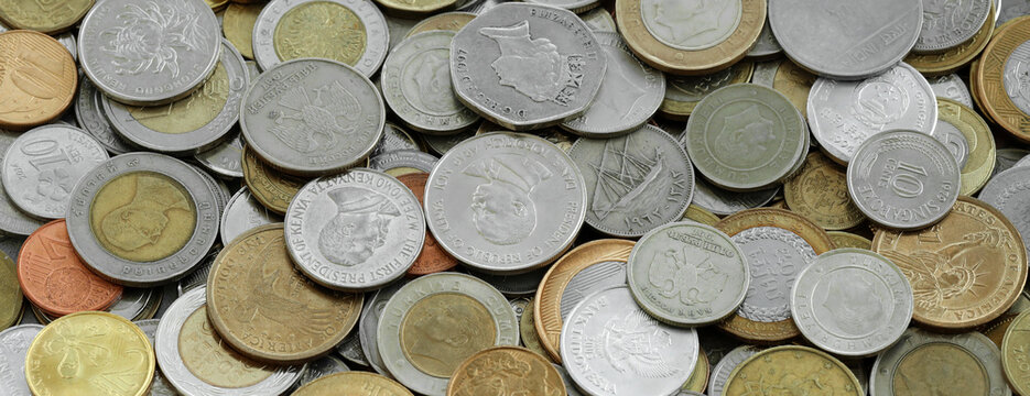 Scattered coins of multiple origins in big mound, detailed shot. World currency variety