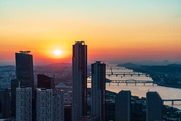 Obraz premium Golden sunset over the financial district of Yeouido with modern corporate skyscrapers in Seoul, South Korea