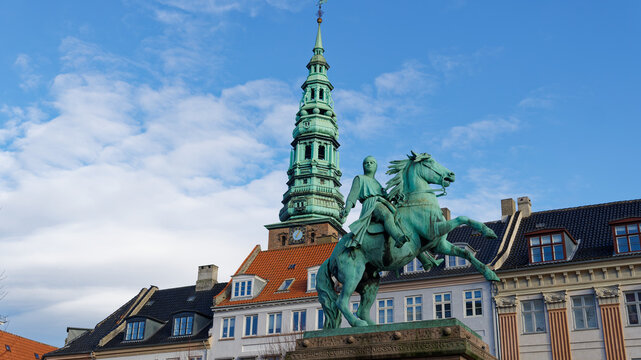 Absalon equestrian statue facing nikolaj church tower in copenhagen