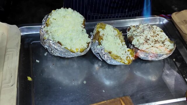 Torching Cheese on Stuffed Baked Potato at Night Market Food Stall
