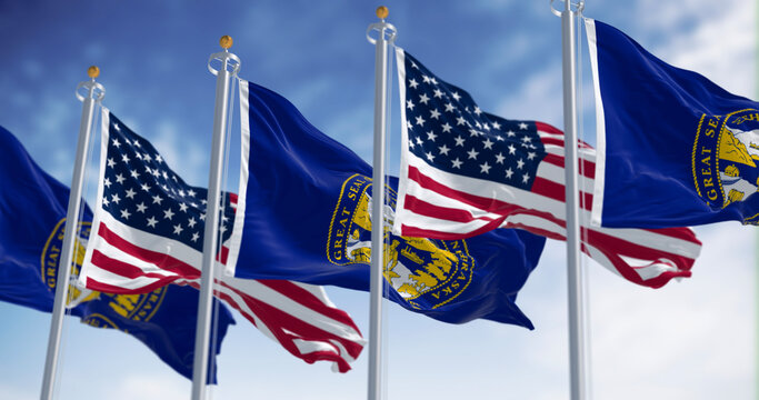 Nebraska state flags waving with the American flags