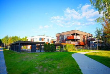 Modern contemporary apartment building with secure gated under croft parking. Development cityscape with housing in low-density. Business-class house with flats. City apartment in multi-family house © MaxSafaniuk