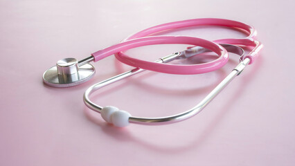 Fototapeta premium Pink stethoscope close up shot on pink background for medical and healthcare concept