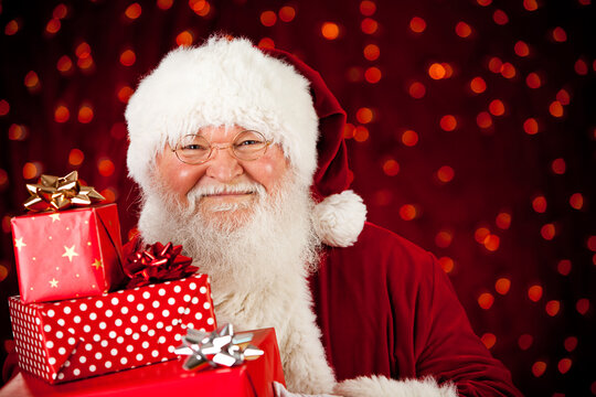 Santa: Holding a Stack of Wrapped Presents