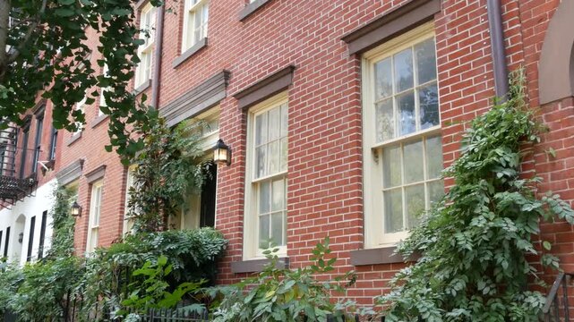 New York City urban residential buildings architecture, Manhattan classic street, Greenwich village, United States of America. Typical red brick house in NYC, real estate property in USA. West village