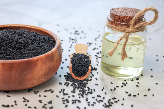 glass bottle of black cumin seeds essential oil 
