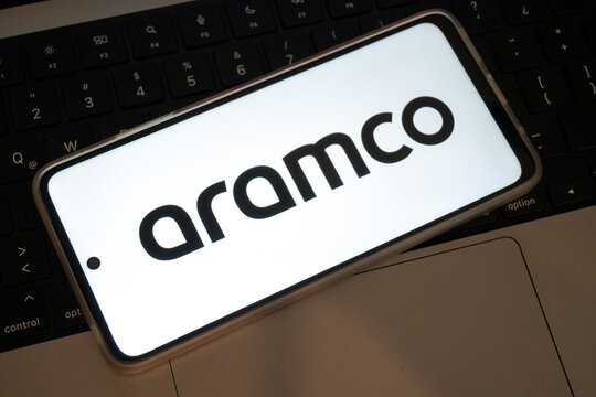 Aramco logo displaying on smartphone screen over keyboard