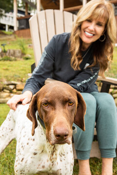 Happy Woman Playing with German Shorthaired Pointer