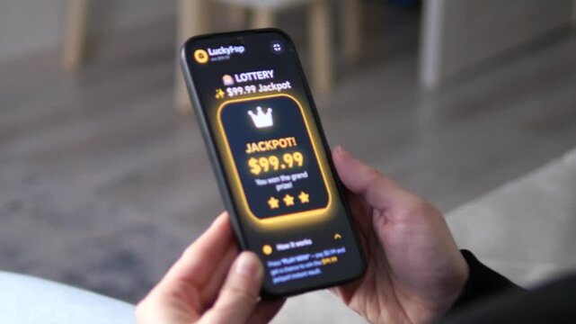 User hitting the 99.99 dollars jackpot on a mobile lottery app. The screen displays a glowing crown and grand prize notification. Ideal for mobile gaming, gambling apps, and luck-based entertainment
