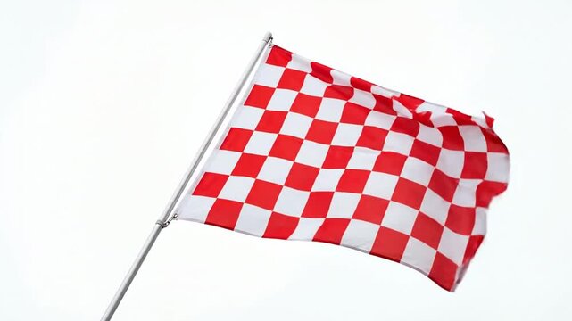 Red and white checkered racing flag waving against white sky