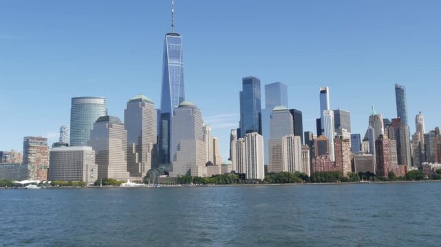 New York City Manhattan Downtown Financial District skyline, World Trade Center tower from ferry boat to New Jersey, United States of America. River waterfront urban cityscape with skyscraper building