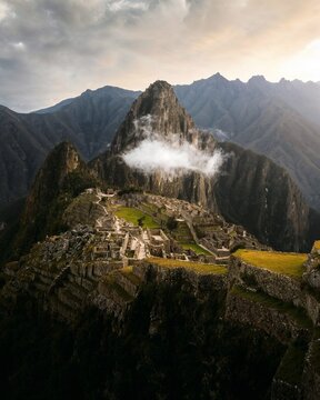 Discover the legendary beauty of Machu Picchu surrounded by majestic Andean peaks and dramatic clouds. An iconic destination blending ancient history, culture, and breathtaking natural landscapes.