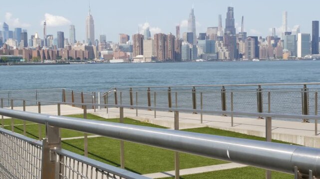 Manhattan Midtown skyline, Edge Park ferry pier promenade, North Williamsburg, New York City USA. East River waterfront, Brooklyn. Financial district skyscrapers architecture. Riverfront cityscape.