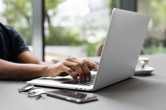 Male hands typing on computer keyboard closeup, business man or student using laptop at home, online learning, internet marketing, people working office workplace, freelance concept