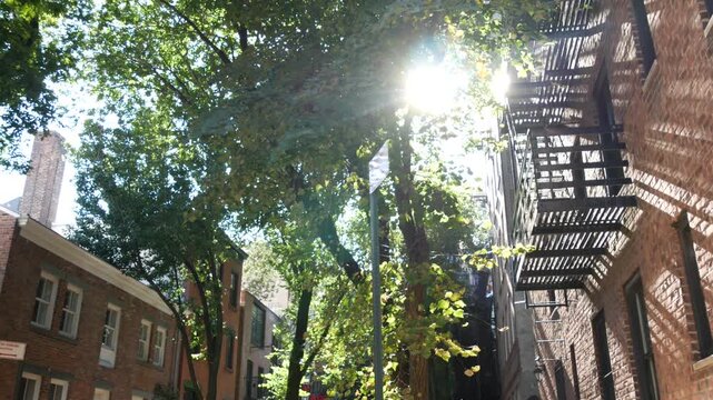 New York City urban residential buildings architecture, Manhattan classic street, Greenwich village, United States of America. Typical red brick house in NYC, real estate property in USA. West village