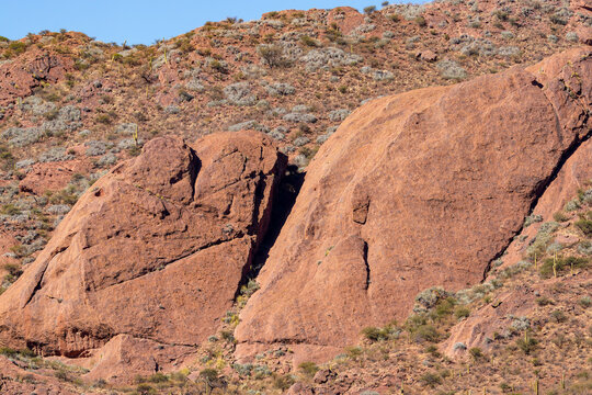 Striking red rock formations and giant cardon cacti characterize the rugged, arid landscape around Laguna de Brealito in Salta, northern Argentina.