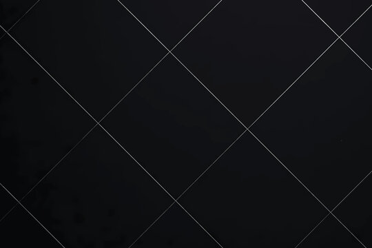 Dark background with diagonal lines forming a grid pattern.
