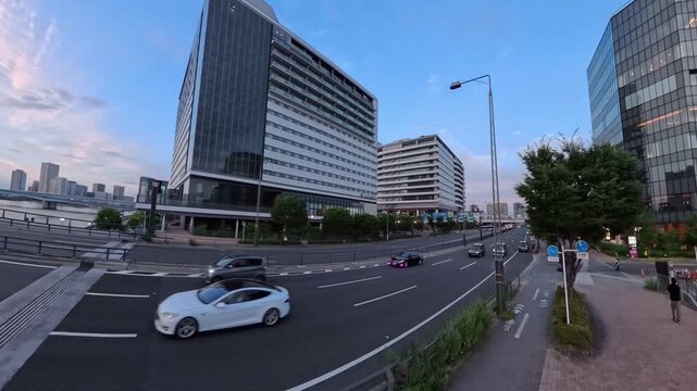 TOKYO, JAPAN - JUNE 2026 : High angle tracking shot of luxury skyscraper apartments and modern waterfront in Toyosu area. Real estate and metropolitan living concept video. Sunset time lapse shot.