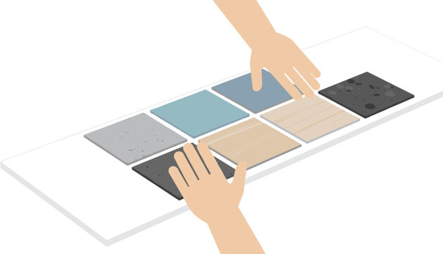 Hands arranging various flooring tile samples on a table to decide on the best interior design material for renovation projects.