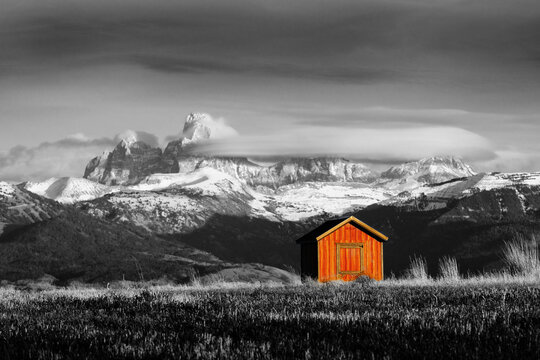 Tetons Mountains with Red Shed or Building in Foreground in Amer