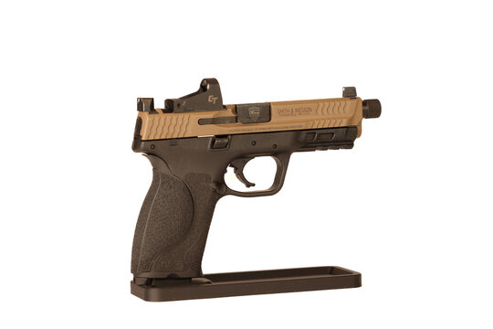 Smith and Wesson MP9 M2.0 9mm Semi-Automatic Pistol with Threaded Barrel, Tan Slide, and Red Dot Optic Mounted on Stand