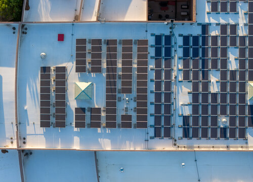 Aerial view of a commercial rooftop covered in rows of solar panels with a skylight and ventilation units in Las Vegas, Nevada, United States.