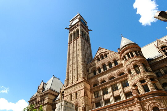 Old City Hall Clock Tower Against Modern Glass Skyscrapers in Toronto &mdash; Historic and Contemporary Architecture Contrast