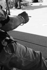 Fototapeta premium Close Up of Hand with Beaded Bracelet Holding Cigarette Outdoors — Candid Street Photography