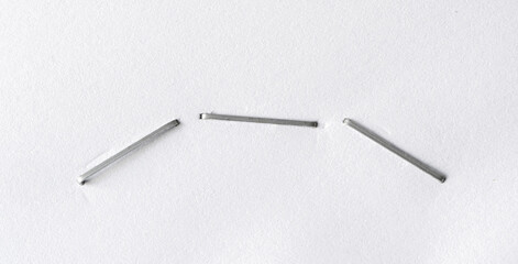 Plakat Staples pushed into a paper, metal office staple needles