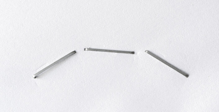 Staples pushed into a paper, metal office staple needles