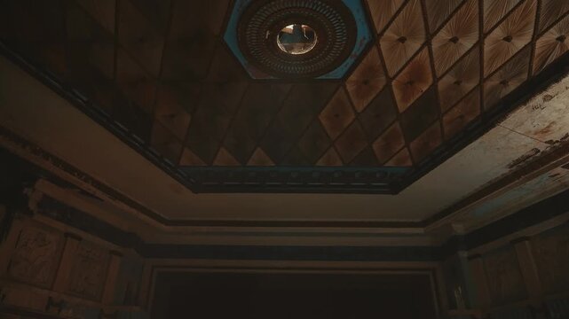 An ornate vintage ceiling features a geometric pattern with a central circular detail. Conceptualizing architecture, interior design, and historical art usage.