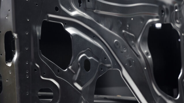 Car door metal sheet. Close up automotive door inner panels and stamped steel body parts. Modern vehicle manufacturing facility. Precision metal forming. Metal Car doors automotive assembly technology