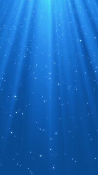 christmas and new year bright blue motion background with shiny stars glitter and particles falling and light flare, vertical social media design element